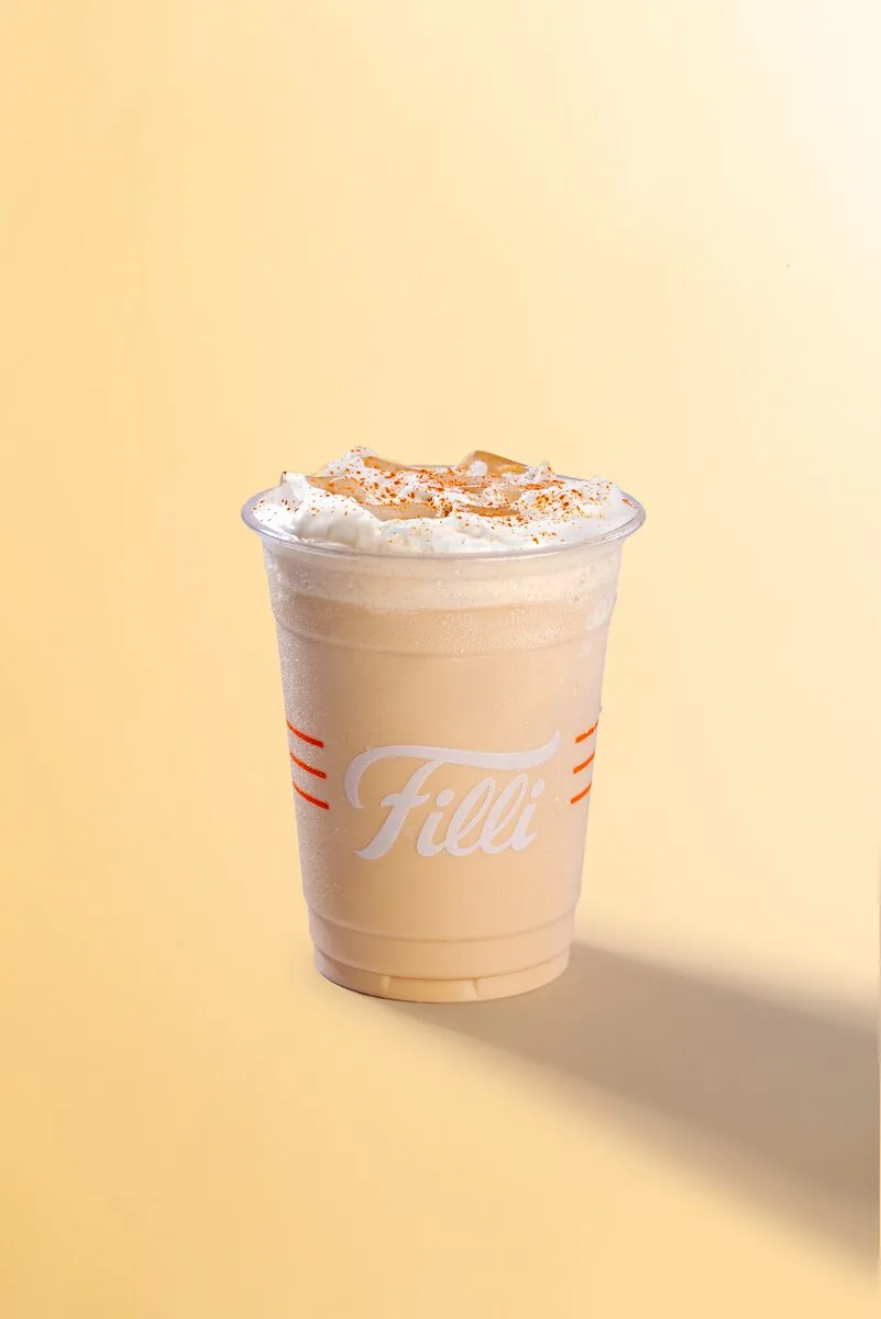 Clear FiLLi cup of iced chai topped with cream