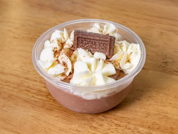 Chocolate mousse topped with cream and chocolate