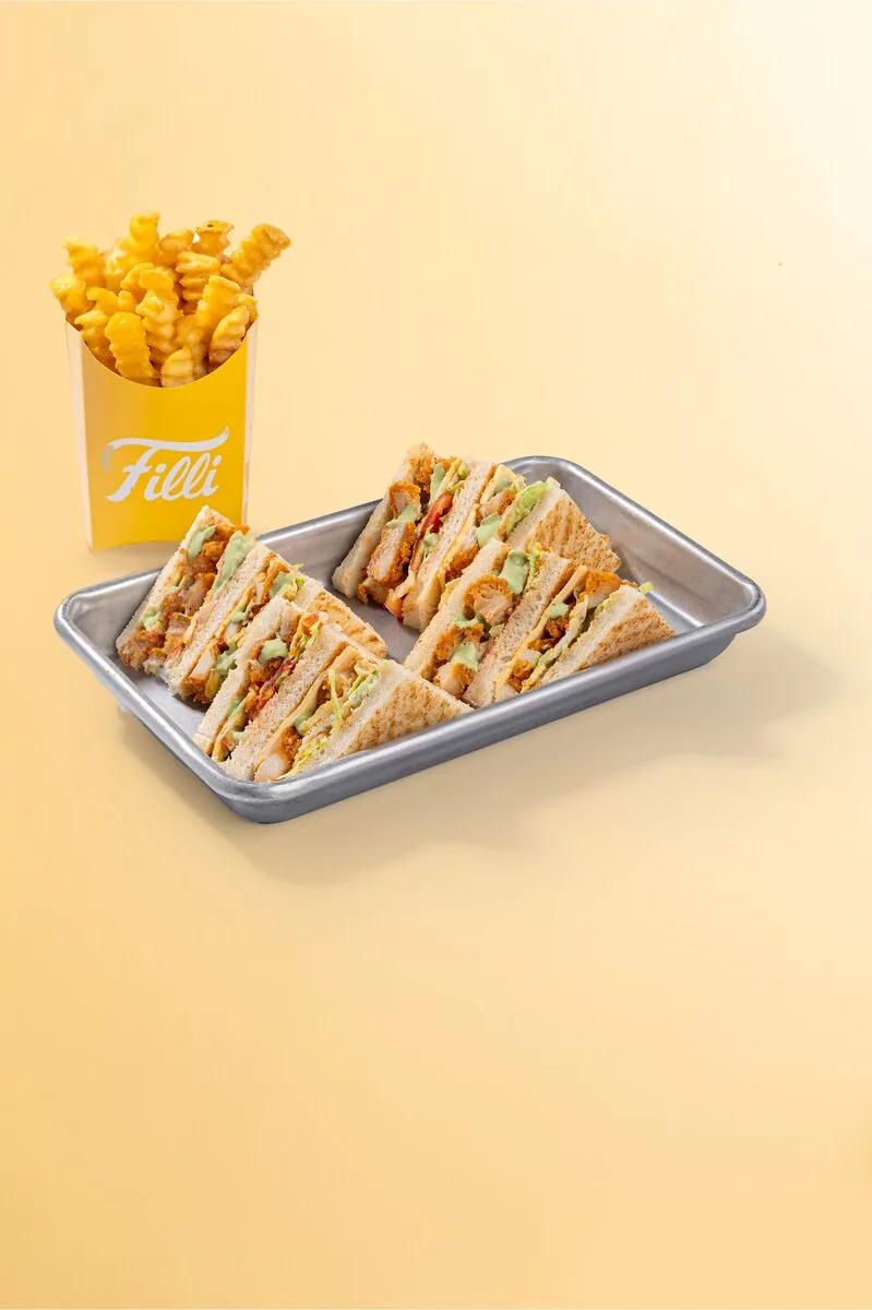 FiLLi chicken club sandwich triangles served with fries