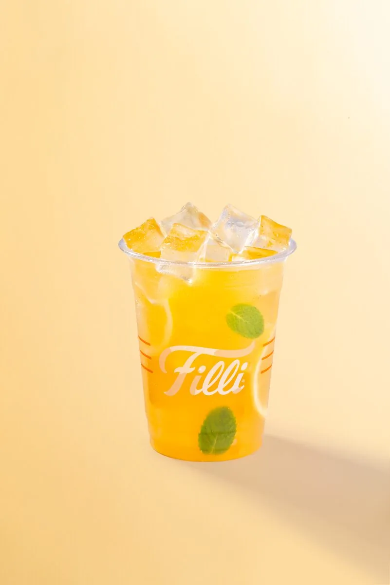 Clear FiLLi cup of passion fruit mojito with ice and lime