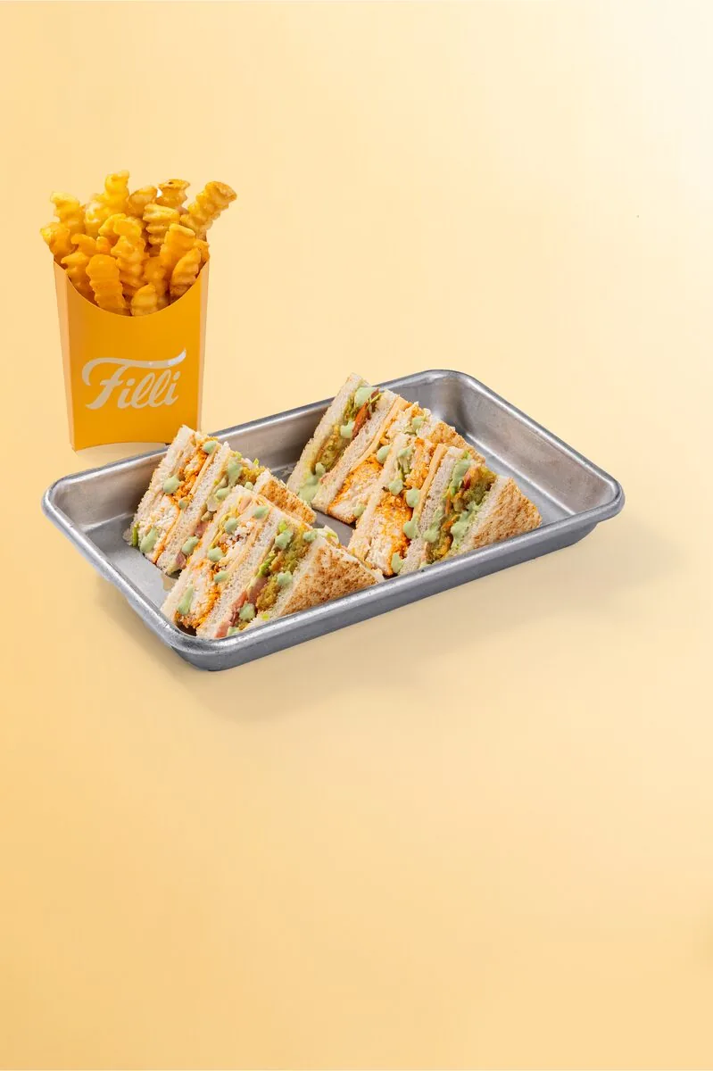Vegetarian club sandwich triangles served with fries