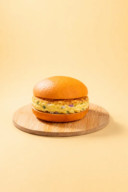 Masala omelette and cheese served in a toasted bun