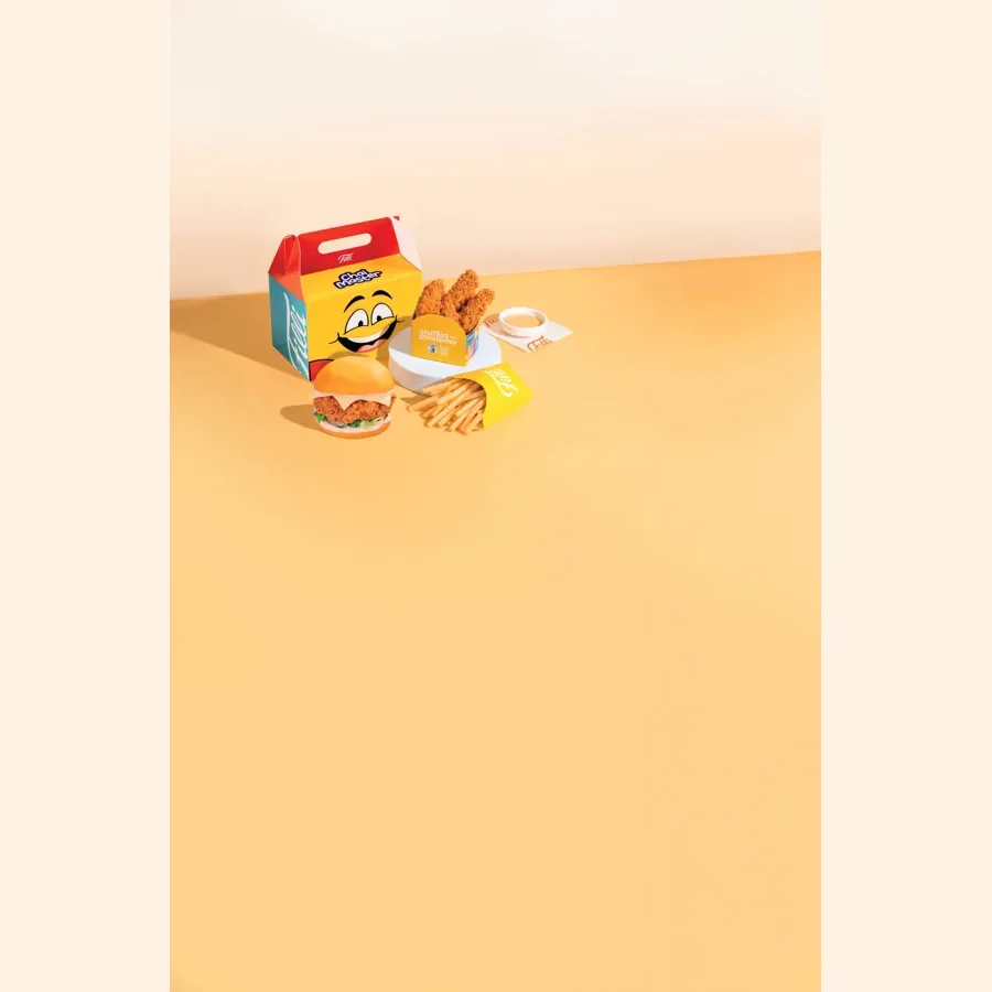 A FiLLi Cafe kid's meal box with a burger, chicken strips, fries and a dip, from the printed FiLLi kid's menu page