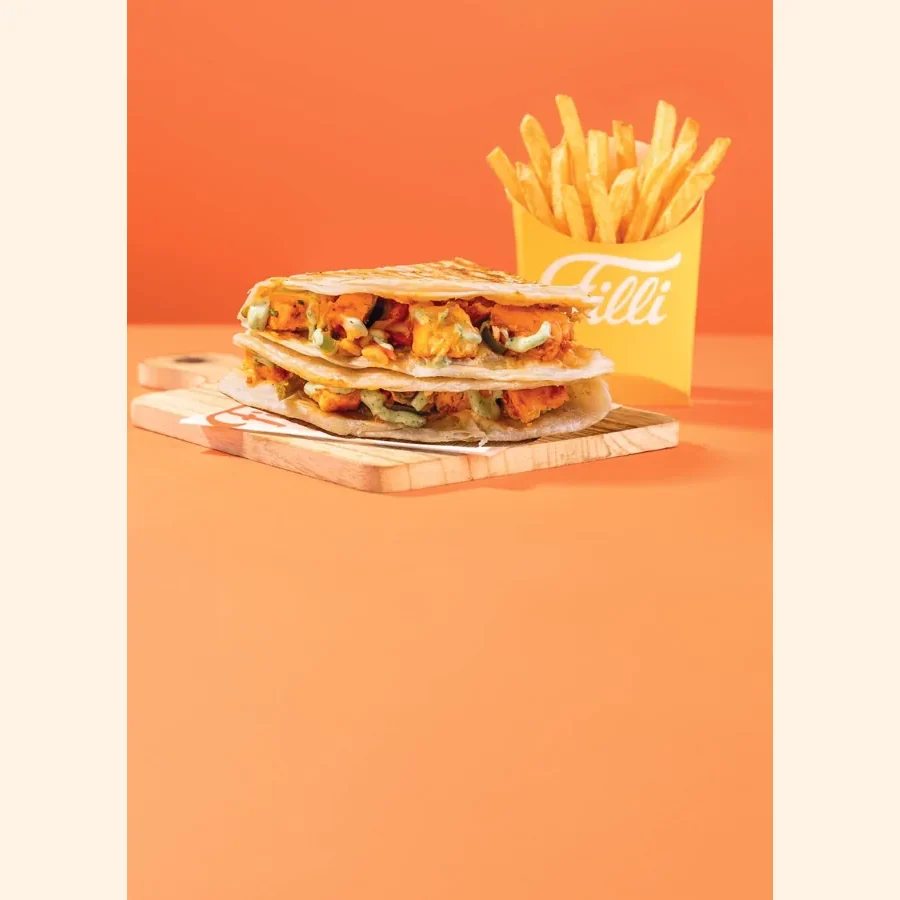 A stacked toasted lacha melt with a carton of fries, from the printed FiLLi lacha melt menu page