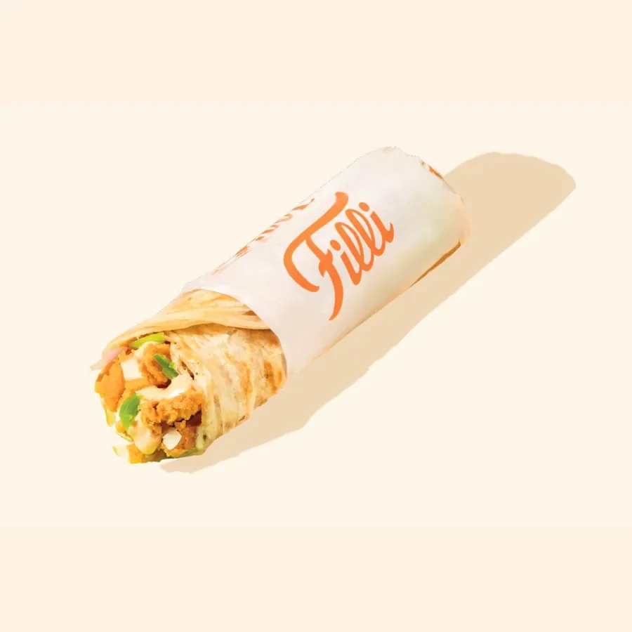 A filled FiLLi Cafe paratha roll in printed paper, from the printed FiLLi paratha menu page